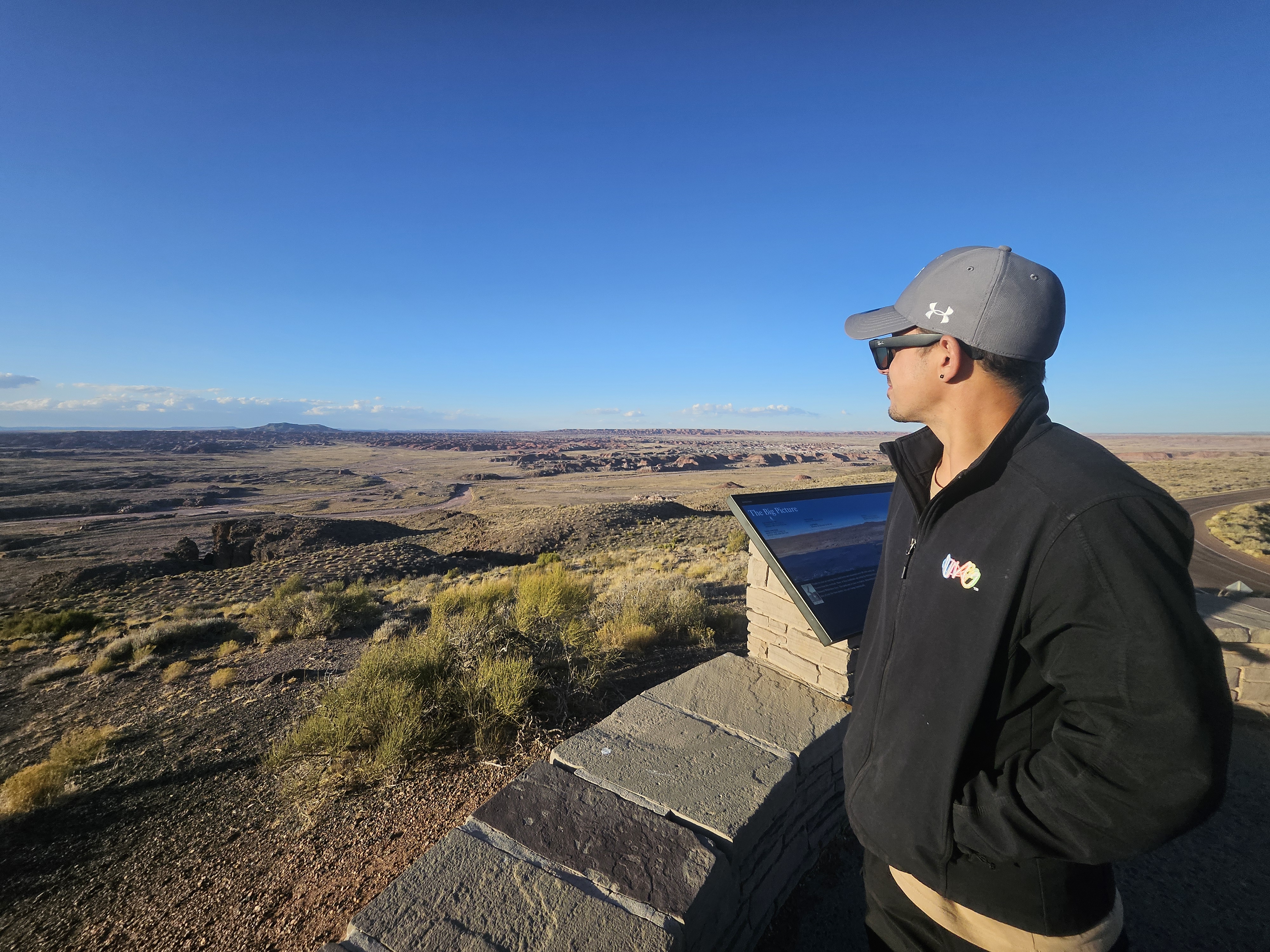 Bobby taking in the view at a scenic overlook — the open road is the office