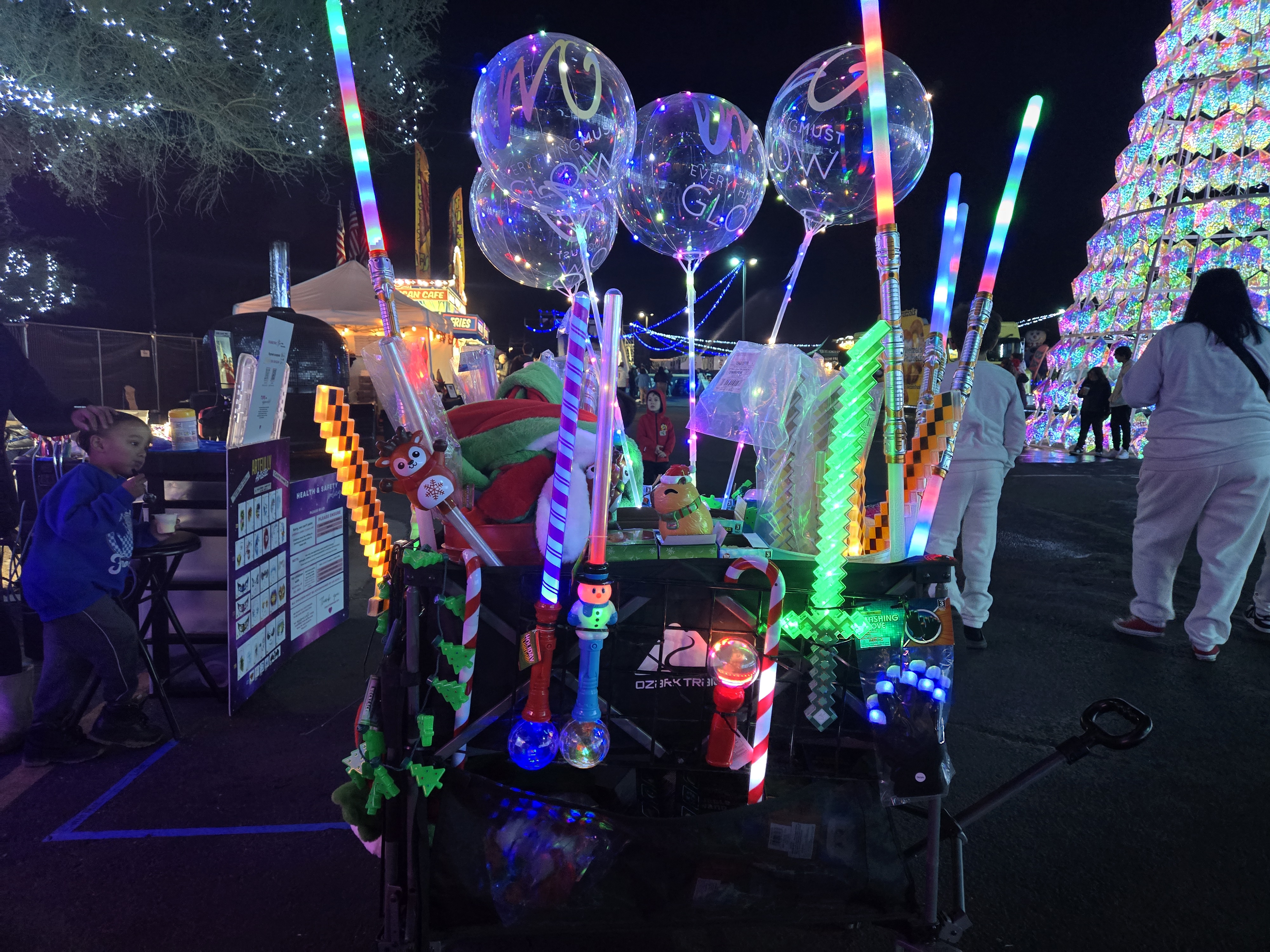 Our holiday glow cart loaded with LED balloons, light-up swords, and festive goodies