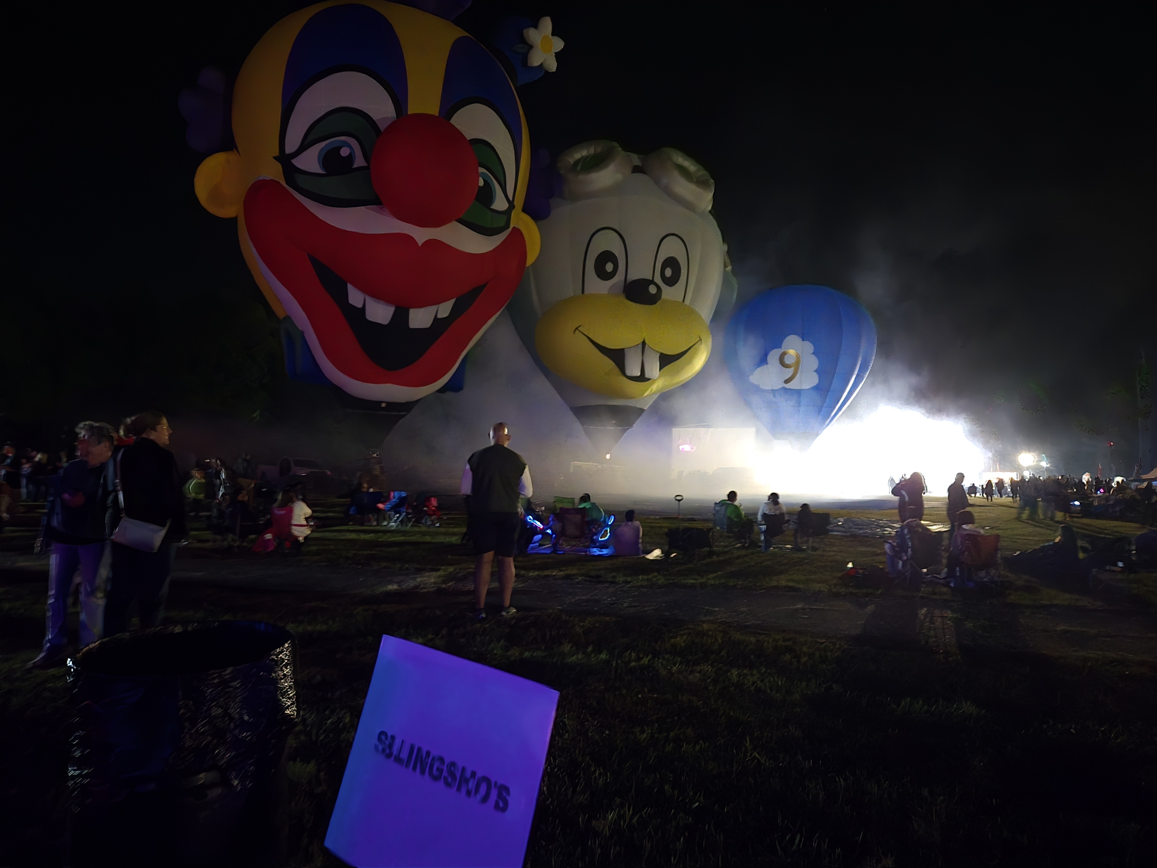 Balloon glow spectacle with our Slingshots sign in the foreground