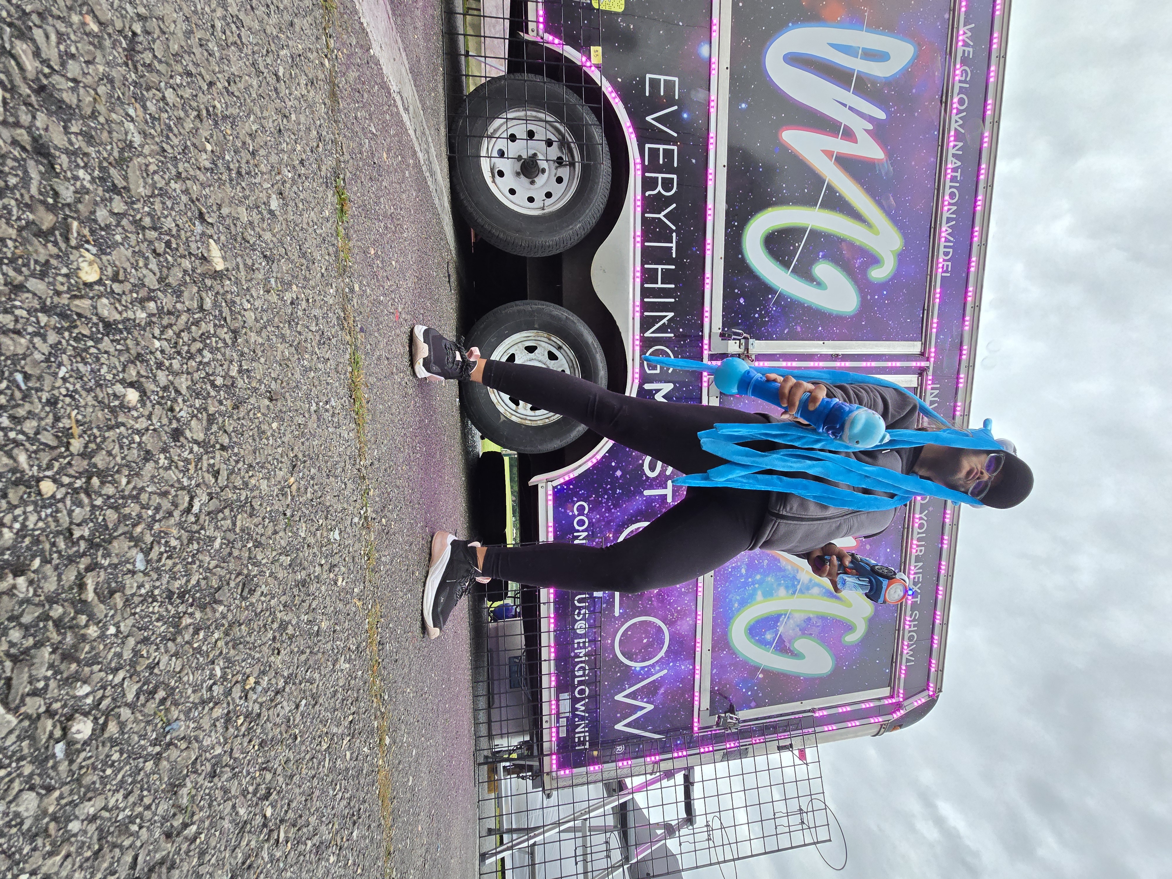 Bobby and his partner smiling in front of the branded trailer — this is the life