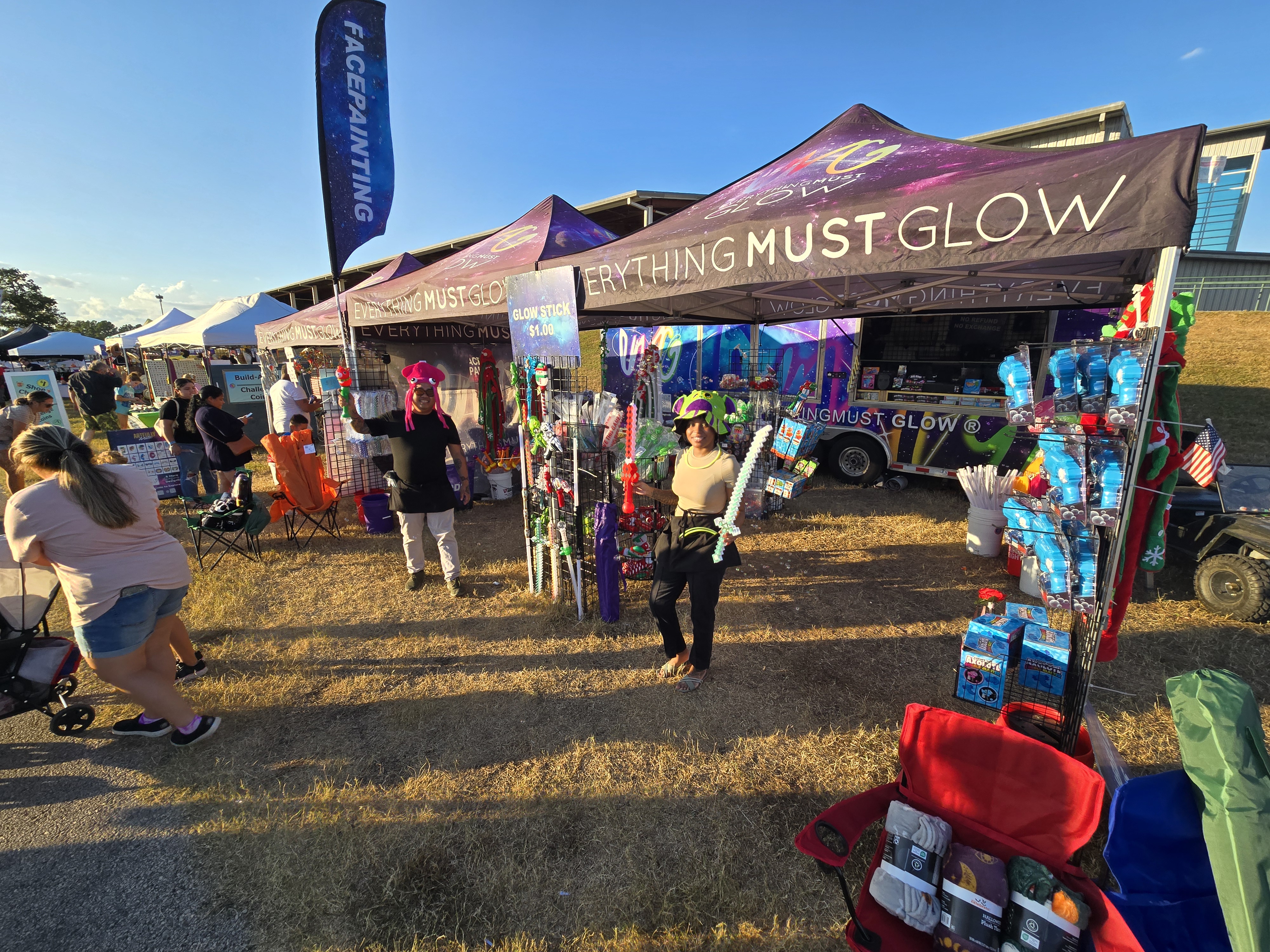 The EMG crew with facepainting station, novelty hats, and the full booth ready to go