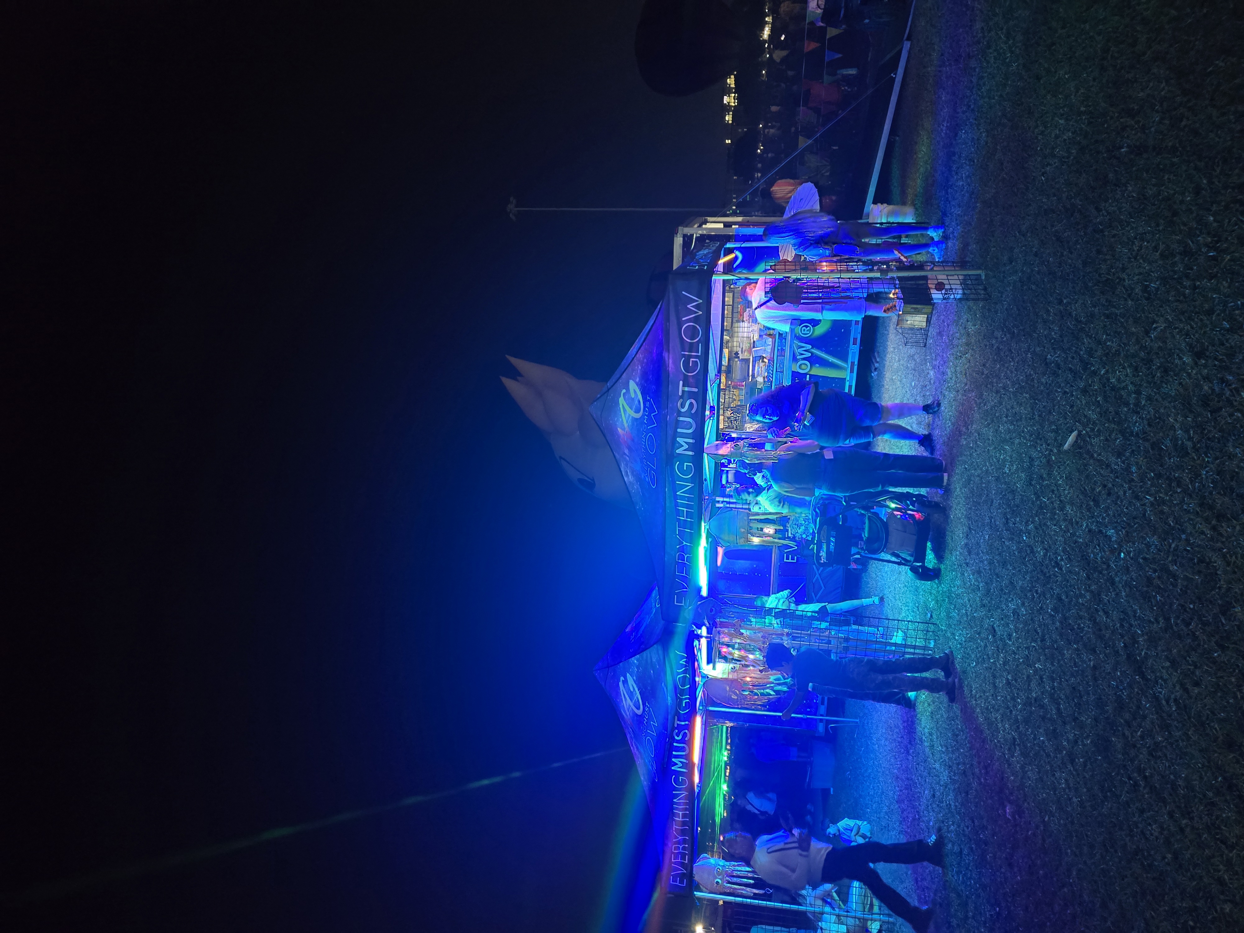 Our EMG booth glowing blue during a drive-in laser light show